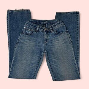 Low-waisted blue jeans with rhinestone embellishments